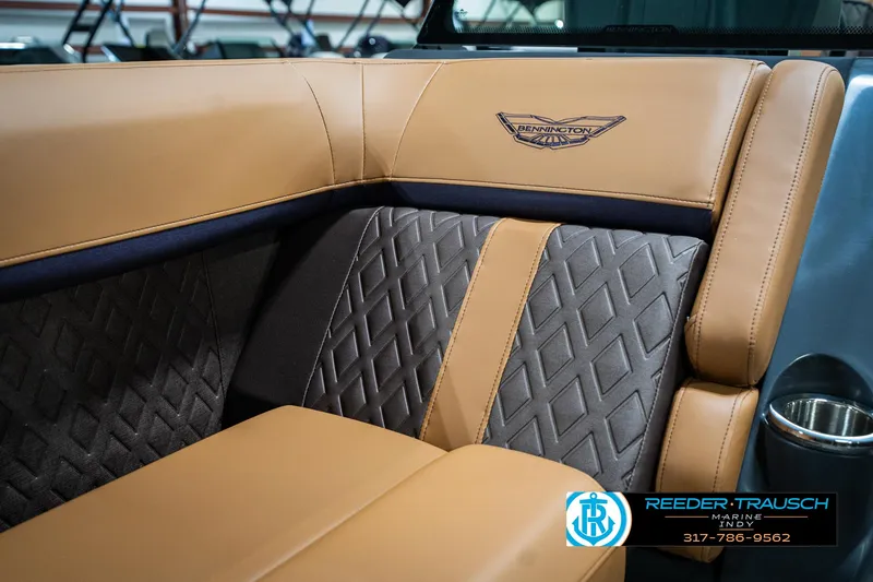 Slide: The Image of 2025 Bennington 24 MSB boat interior with tan and gray diamond-stitched upholstery. - 39
