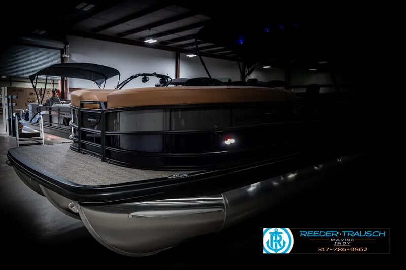 Slide: The Image of 2025 Bennington 24 MSB pontoon boat in showroom, sleek design, low lighting. - 4
