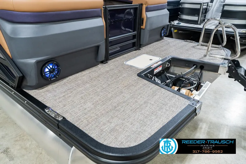 Slide: The Image of 2025 Bennington 24 MSB boat interior with storage compartment and speakers. - 49