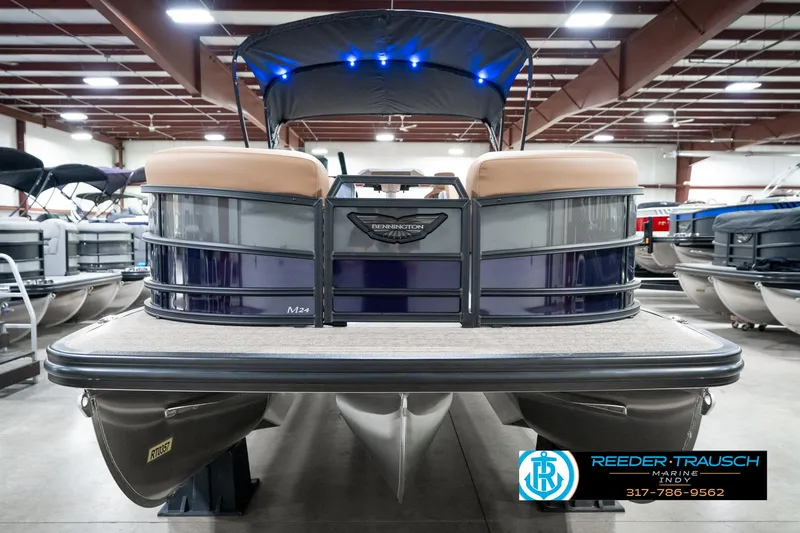 Slide: The Image of 2025 Bennington 24 MSB pontoon boat in showroom with blue LED lights. - 5