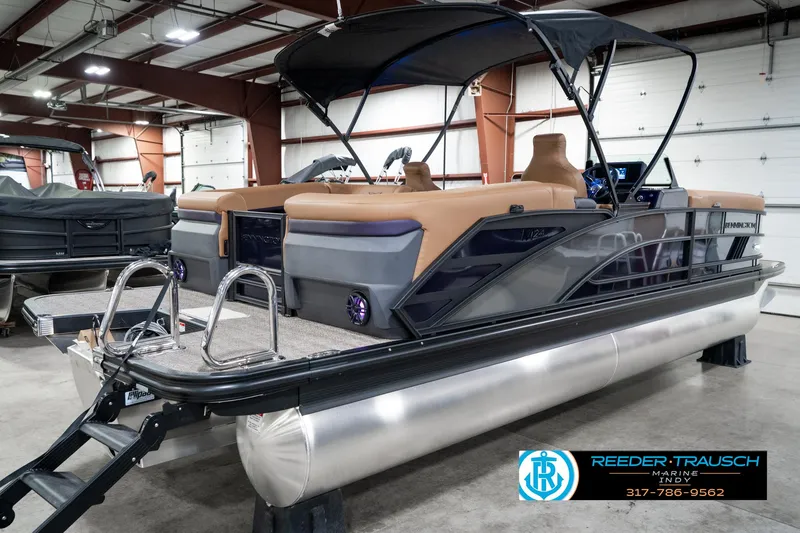 Slide: The Image of 2025 Bennington 24 MSB pontoon boat in showroom with canopy and ladder. - 8
