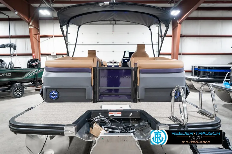 Slide: The Image of 2025 Bennington 24 MSB pontoon boat in showroom, featuring spacious seating and modern design. - 9