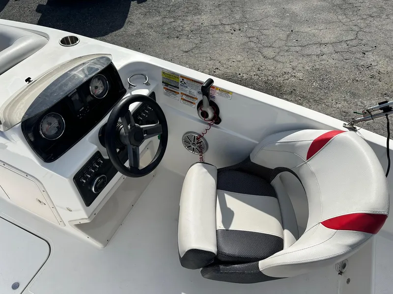 Slide: The Image of 2018 Godfrey Hurricane 188SD boat cockpit with steering wheel and cushioned seat. - 5