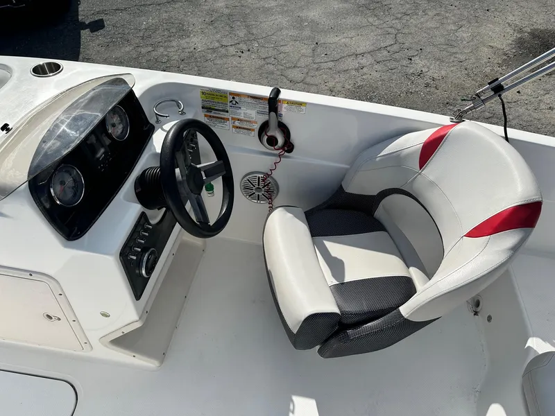 Slide: The Image of 2018 Godfrey Hurricane 188SD boat cockpit with steering wheel and cushioned seat. - 9