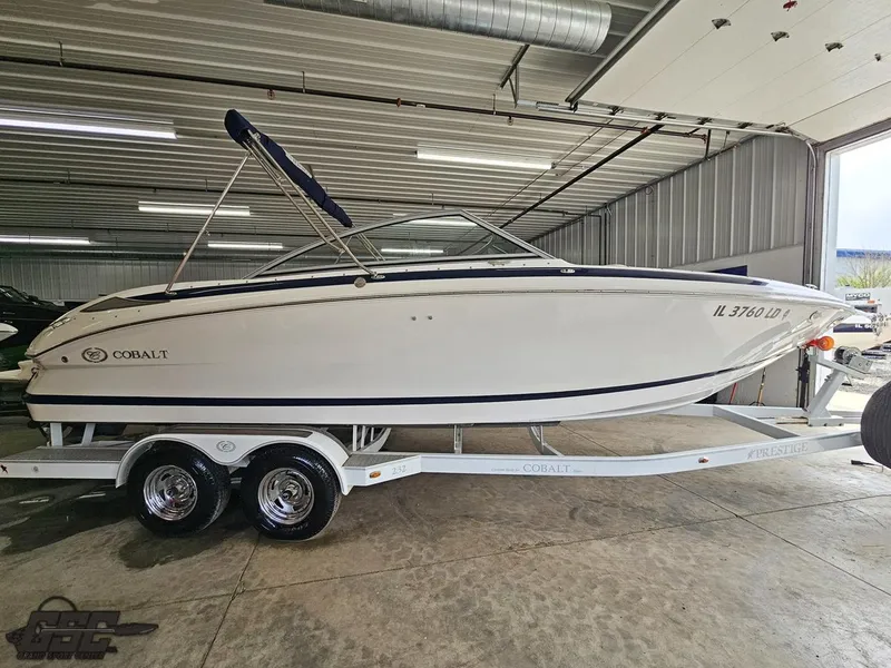 Slide: The Image of 2009 Cobalt 232 boat on trailer in indoor storage facility. - 1