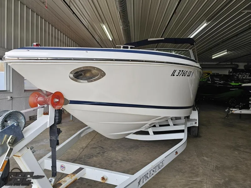 Slide: The Image of 2009 Cobalt 232 boat on trailer in indoor storage facility. - 10