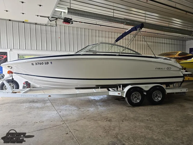 Slide: The Image of 2009 Cobalt 232 boat on trailer in indoor storage facility. - 11