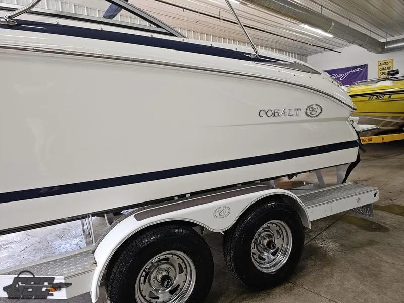 Slide: The Image of 2009 Cobalt 232 boat on trailer in indoor storage facility. - 12