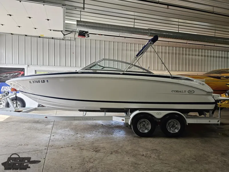Slide: The Image of 2009 Cobalt 232 boat on trailer in a garage setting. - 15