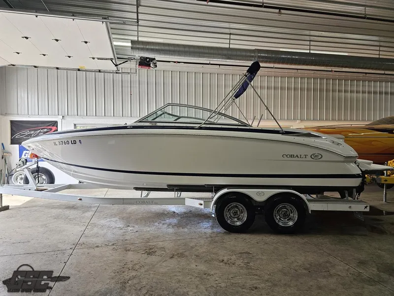 Slide: The Image of 2009 Cobalt 232 boat on trailer in indoor storage facility. - 16