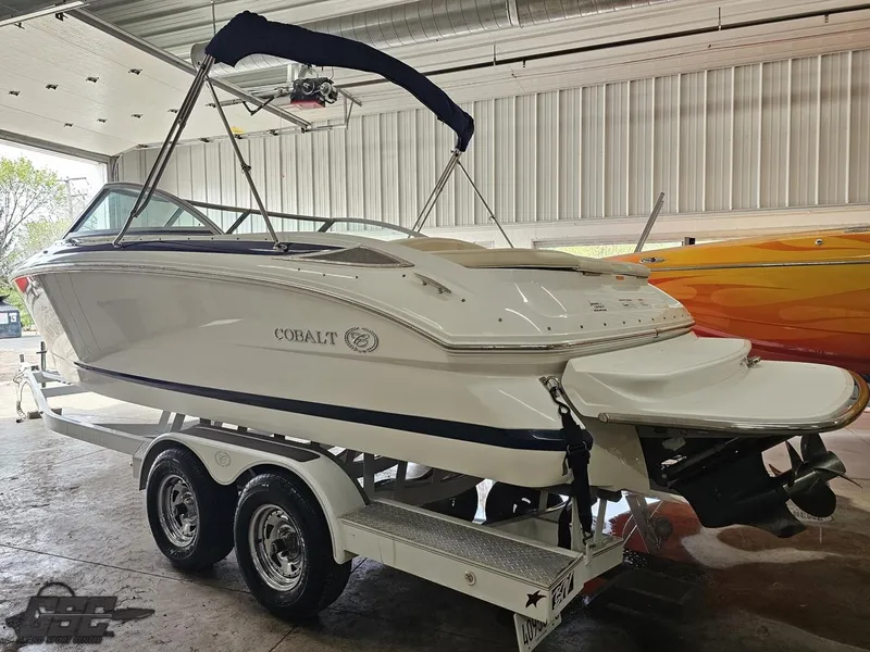 Slide: The Image of 2009 Cobalt 232 boat on trailer in indoor storage facility. - 17
