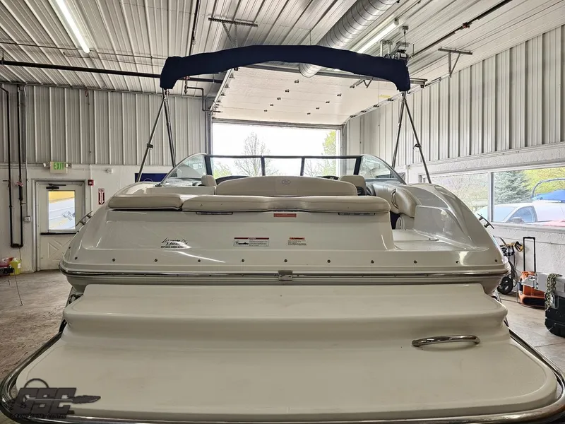 Slide: The Image of 2009 Cobalt 232 boat in a garage, rear view with open canopy. - 19