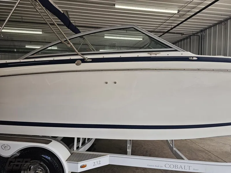 Slide: The Image of 2009 Cobalt 232 boat on trailer in a storage facility. - 2