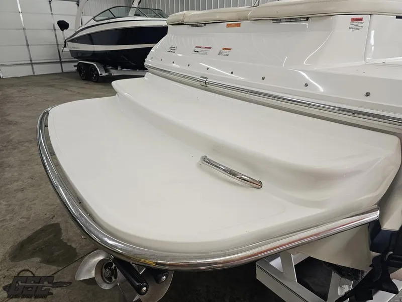 Slide: The Image of 2009 Cobalt 232 boat with swim platform in a garage setting. - 21