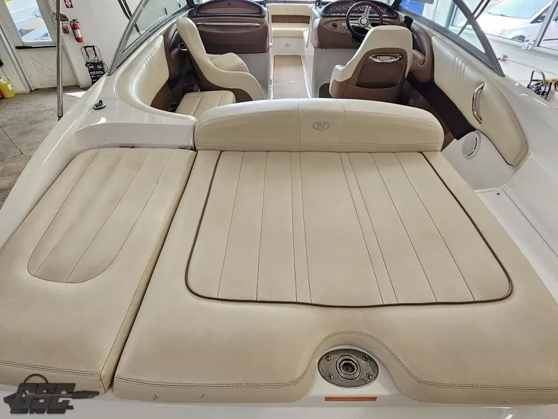 Slide: The Image of 2009 Cobalt 232 boat interior with beige seating and steering wheel. - 23