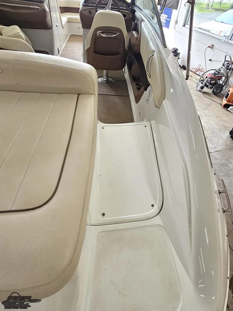 Slide: The Image of 2009 Cobalt 232 boat interior with beige seating and white deck. - 25