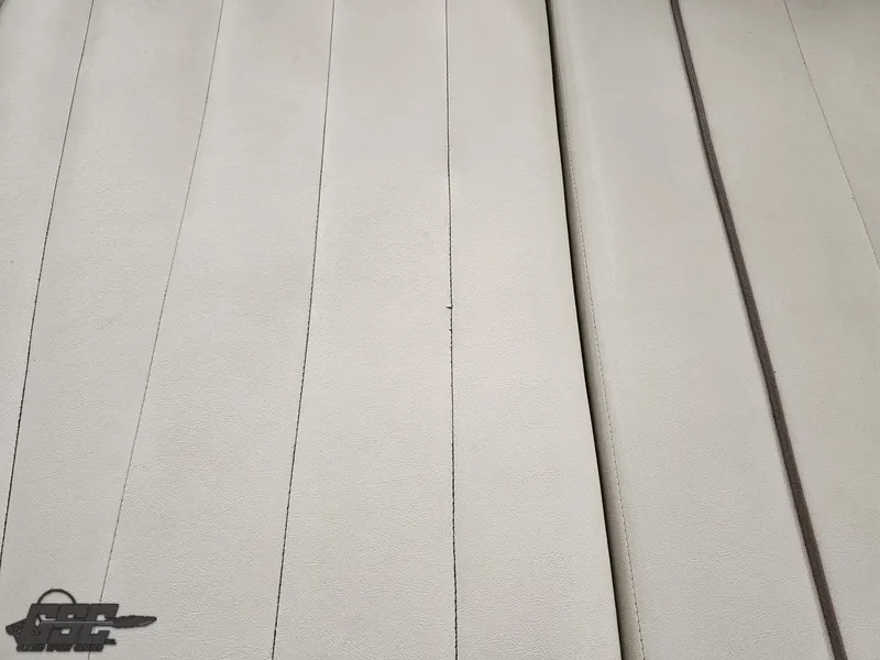 Slide: The Image of Beige upholstery of a 2009 Cobalt 232 boat, featuring vertical stitching. - 26