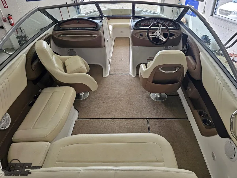 Slide: The Image of Interior of a 2009 Cobalt 232 boat with beige and brown seating. - 27