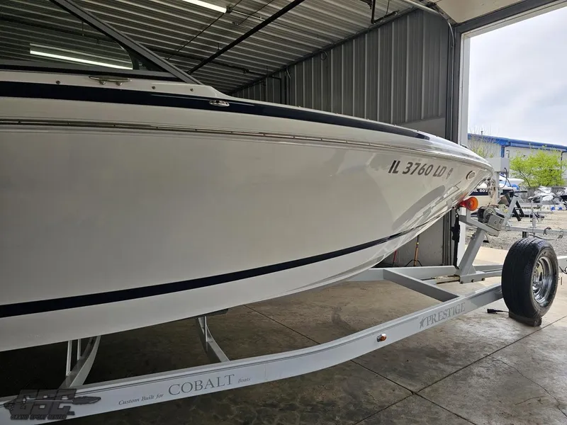 Slide: The Image of 2009 Cobalt 232 boat on trailer in garage, side view. - 3