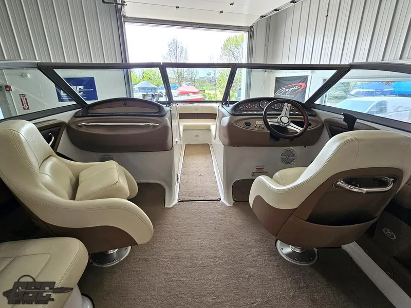 Slide: The Image of Interior of a 2009 Cobalt 232 boat with beige and brown seating. - 30