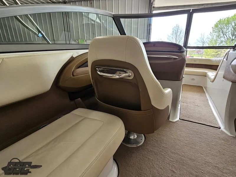 Slide: The Image of Interior of a 2009 Cobalt 232 boat with beige and brown seating. - 32