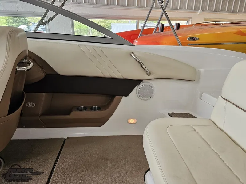 Slide: The Image of Interior of a 2009 Cobalt 232 boat with beige seating and modern design. - 33