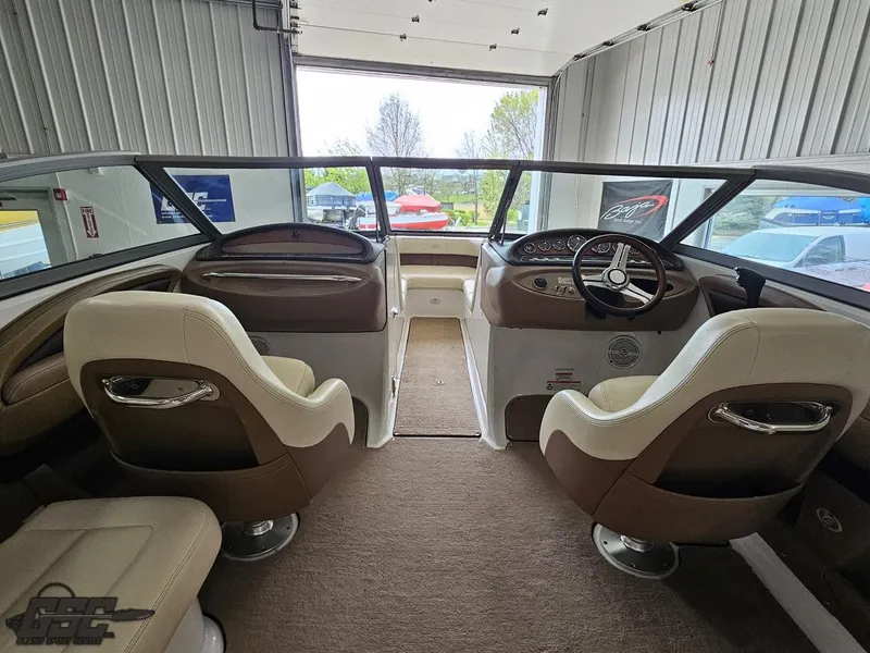 Slide: The Image of Interior of a 2009 Cobalt 232 boat with dual captain's chairs and dashboard. - 34