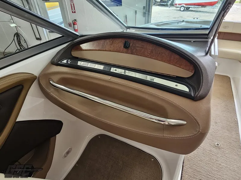 Slide: The Image of Interior view of a 2009 Cobalt 232 boat, featuring a sleek dashboard design. - 39