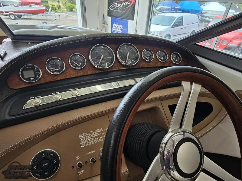 Slide: The Image of 2009 Cobalt 232 dashboard with wood accents and classic steering wheel design. - 43