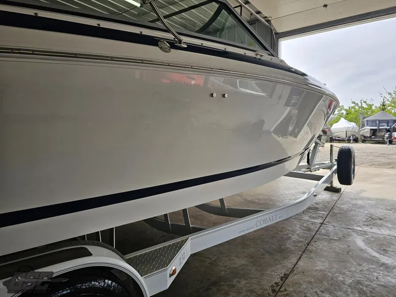 Slide: The Image of 2009 Cobalt 232 boat on trailer in garage, side view. - 6