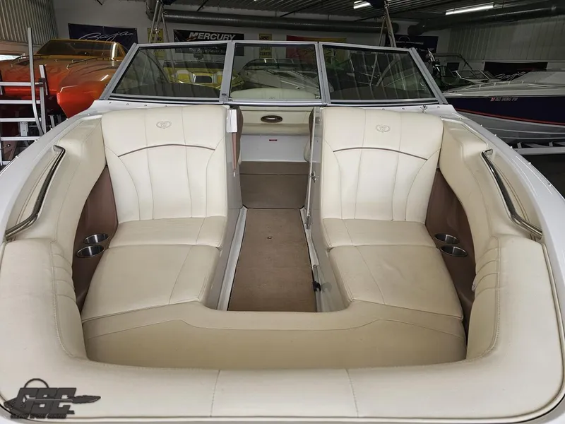 Slide: The Image of 2009 Cobalt 232 boat interior with beige seating and open bow design. - 9