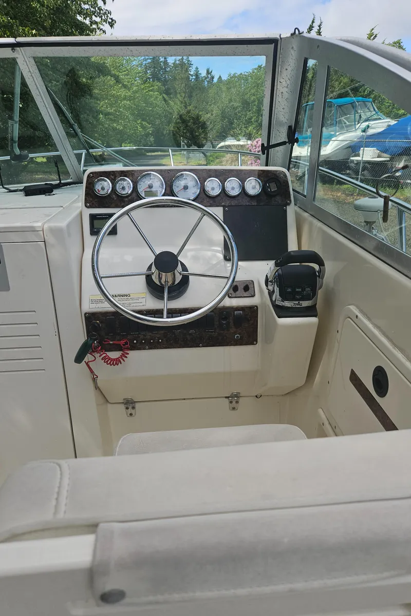 Slide: The Image of 1999 Pursuit 2460 Denali boat cockpit with steering wheel and instrument panel. - 5