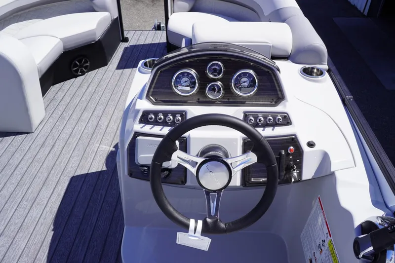 Slide: The Image of 2025 Lowe SS 210 DL boat dashboard with steering wheel and gauges. - 10