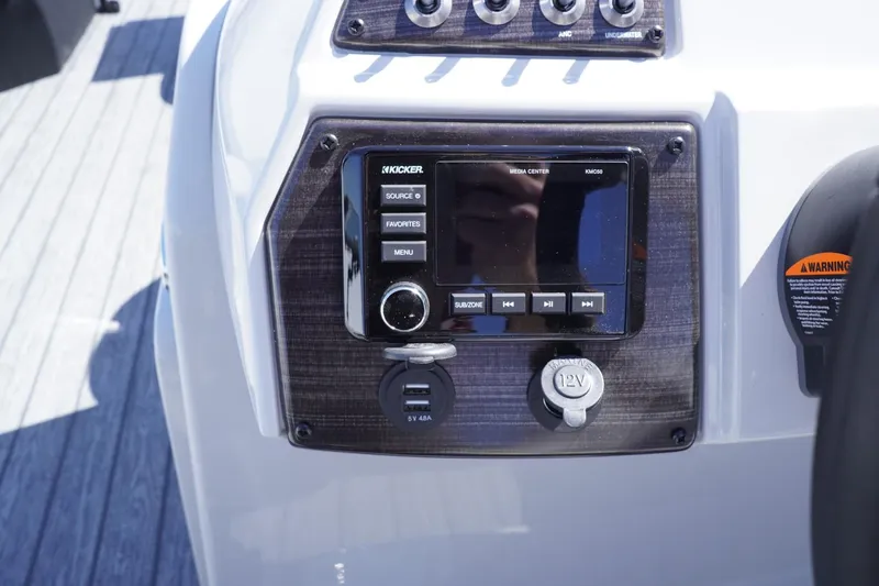 Slide: The Image of Control panel of 2025 Lowe SS 210 DL boat with audio system and USB ports. - 12
