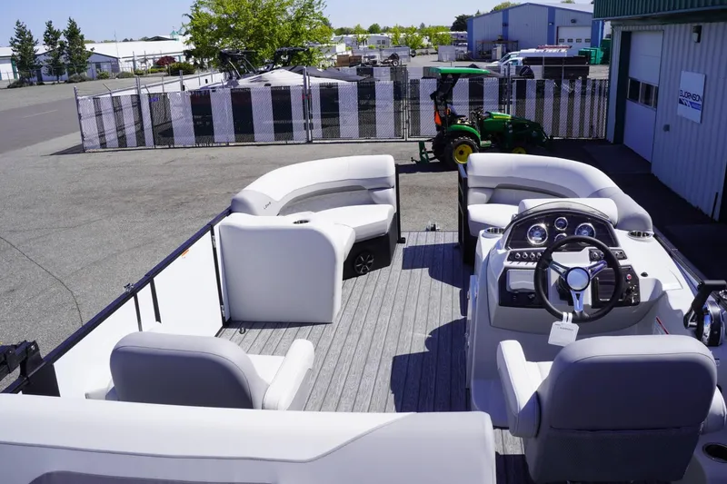 Slide: The Image of 2025 Lowe SS 210 DL pontoon boat with spacious seating and modern dashboard. - 14