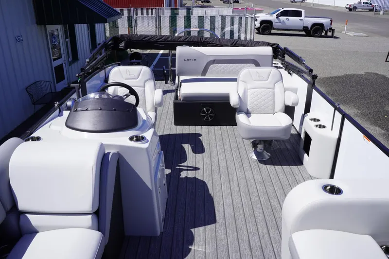 Slide: The Image of 2025 Lowe SS 210 DL pontoon boat interior with modern seating and steering console. - 8