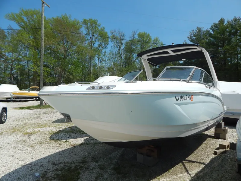 Slide: The Image of 2019 Chaparral 230 Suncoast boat on display in outdoor setting. - 1