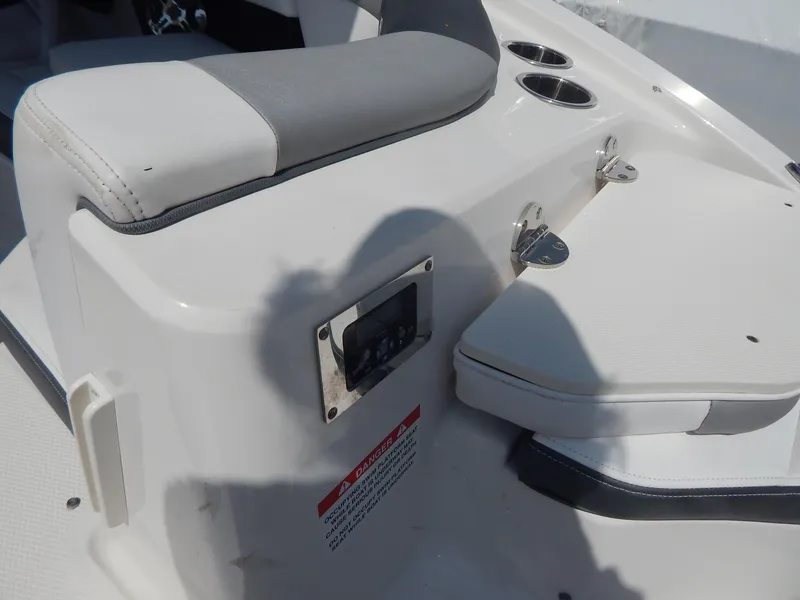 Slide: The Image of 2019 Chaparral 230 Suncoast boat interior with seating and cup holders. - 12