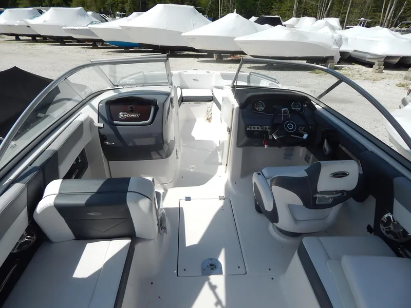 Slide: The Image of 2019 Chaparral 230 Suncoast boat interior with seating and dashboard view. - 13