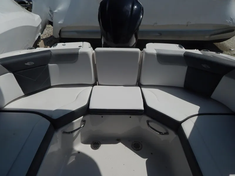 Slide: The Image of 2019 Chaparral 230 Suncoast boat interior with cushioned seating and storage compartments. - 21