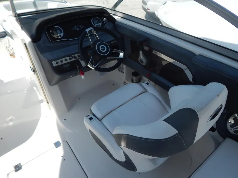 Slide: The Image of 2019 Chaparral 230 Suncoast boat interior with steering wheel and captain's seat. - 22