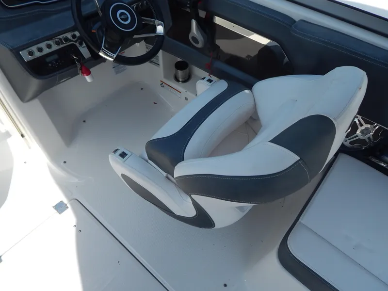 Slide: The Image of 2019 Chaparral 230 Suncoast boat interior with steering wheel and captain's chair. - 23