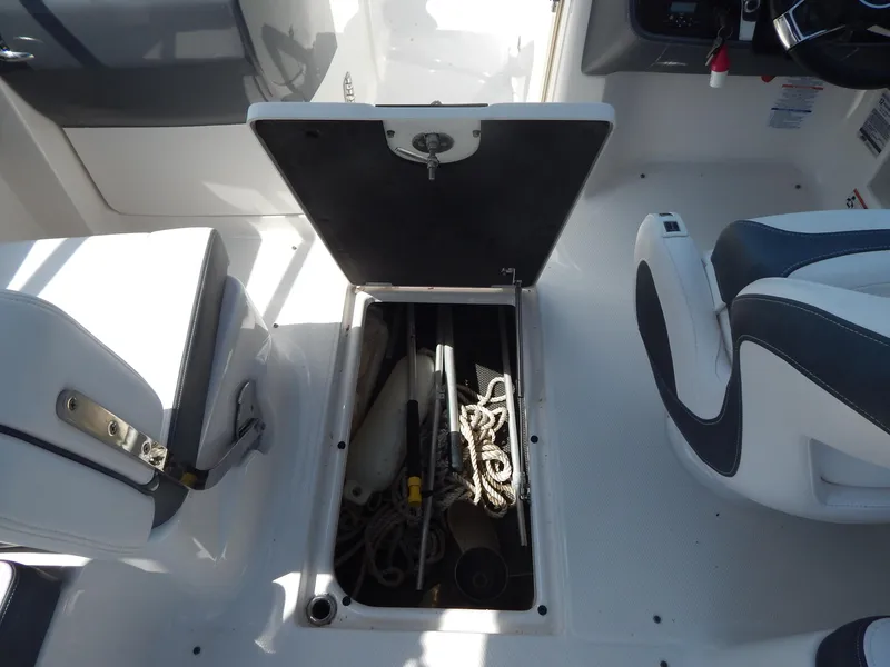 Slide: The Image of 2019 Chaparral 230 Suncoast boat storage compartment with ropes and equipment. - 25