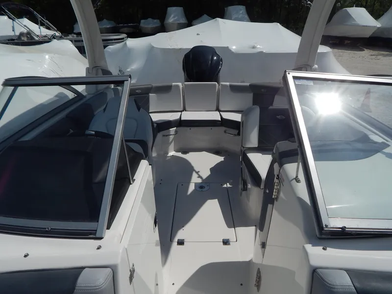 Slide: The Image of 2019 Chaparral 230 Suncoast boat interior with open cockpit and seating. - 33