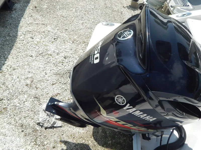 Slide: The Image of Yamaha outboard motor on 2019 Chaparral 230 Suncoast boat, parked on gravel. - 36