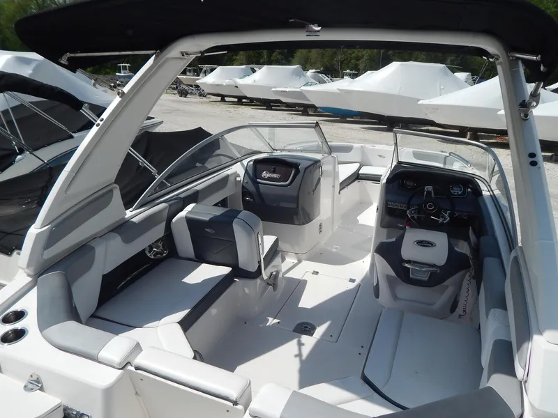 Slide: The Image of 2019 Chaparral 230 Suncoast boat interior with seating and steering console. - 37