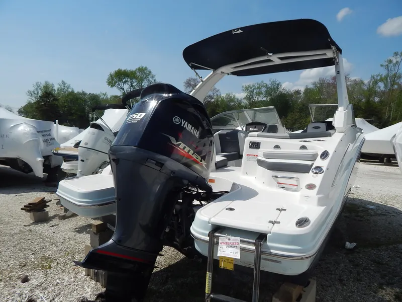 Slide: The Image of 2019 Chaparral 230 Suncoast boat with Yamaha outboard engine, parked outdoors. - 4