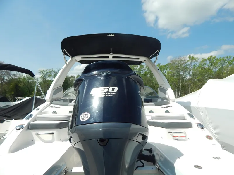 Slide: The Image of 2019 Chaparral 230 Suncoast boat with powerful 250 HP engine, under clear blue sky. - 6
