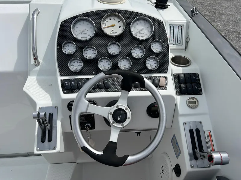 Slide: The Image of 2006 Baja Outlaw boat dashboard with steering wheel and gauges. - 10
