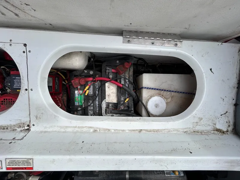 Slide: The Image of 2006 Baja Outlaw boat battery compartment with wiring and storage container. - 15